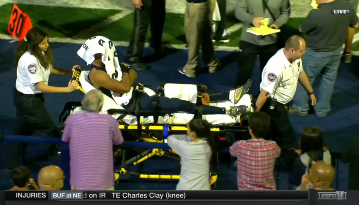 Trevon Grimes being carted off of the field.