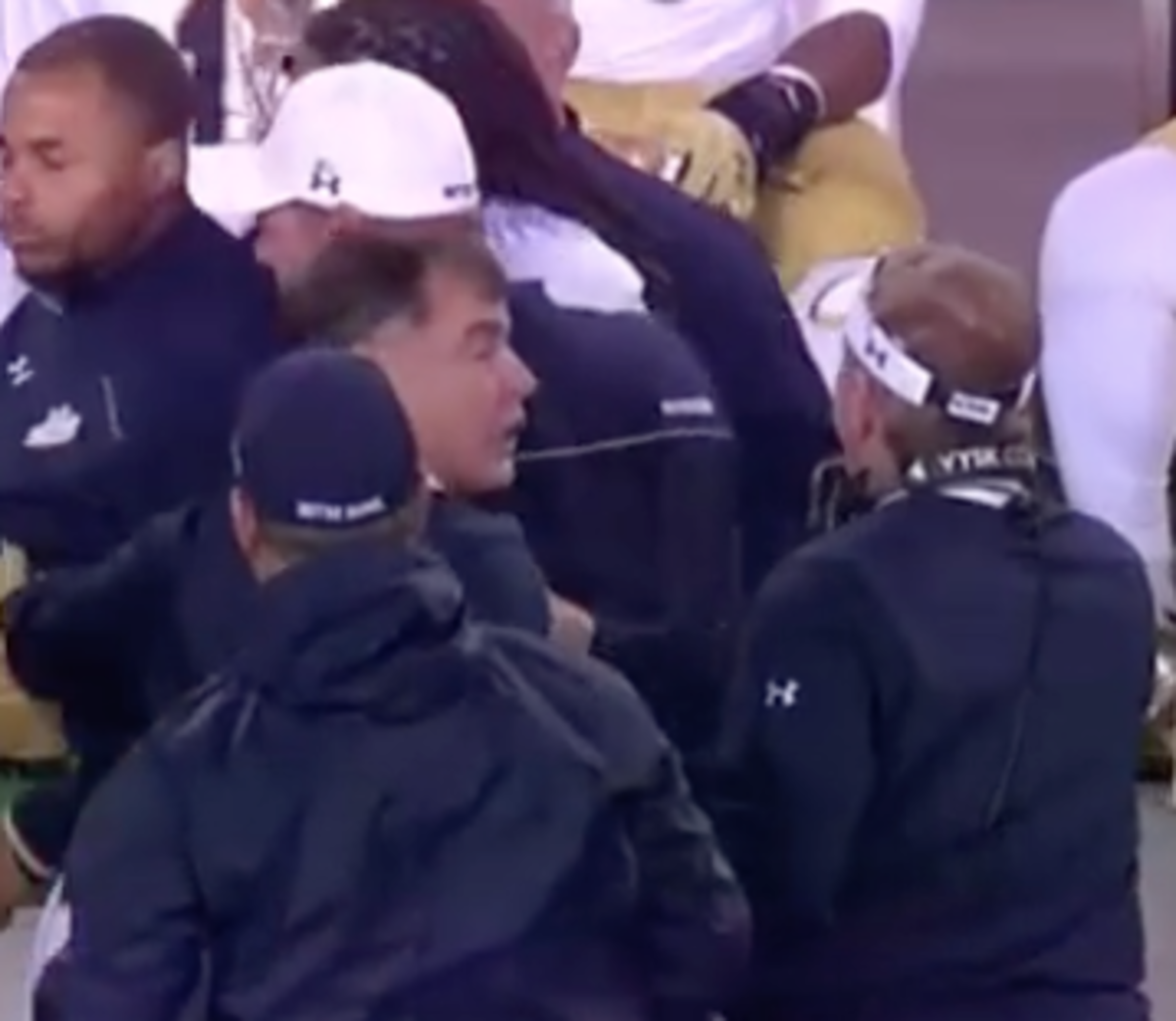 Brian Kelly gets restrained after fighting Irish strength coach.