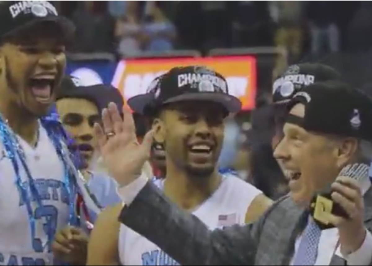 UNC players and Roy Williams celebrate after ACC tournament win.