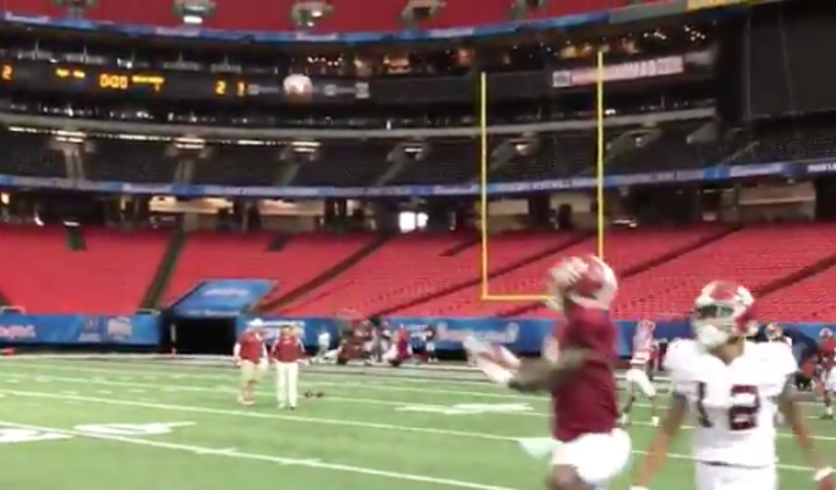 Nick Saban throws the ball to one of his team's wideouts.