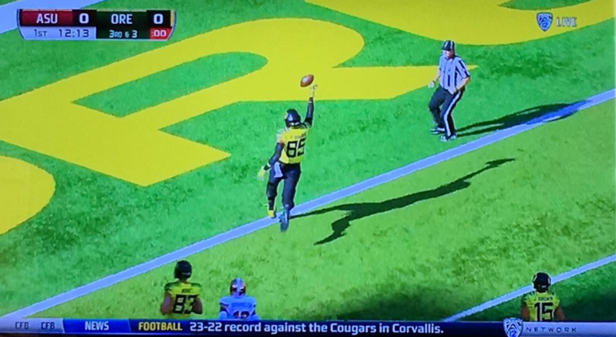 Oregon player dropping the ball before crossing the goal line