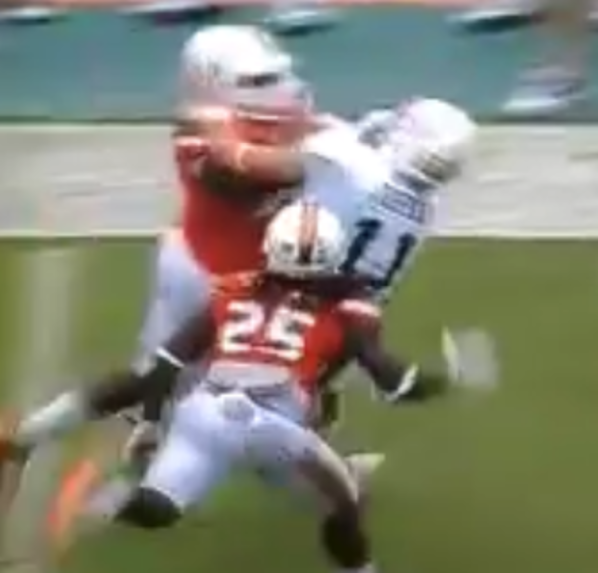 Miami player stiff arms a player to the ground.