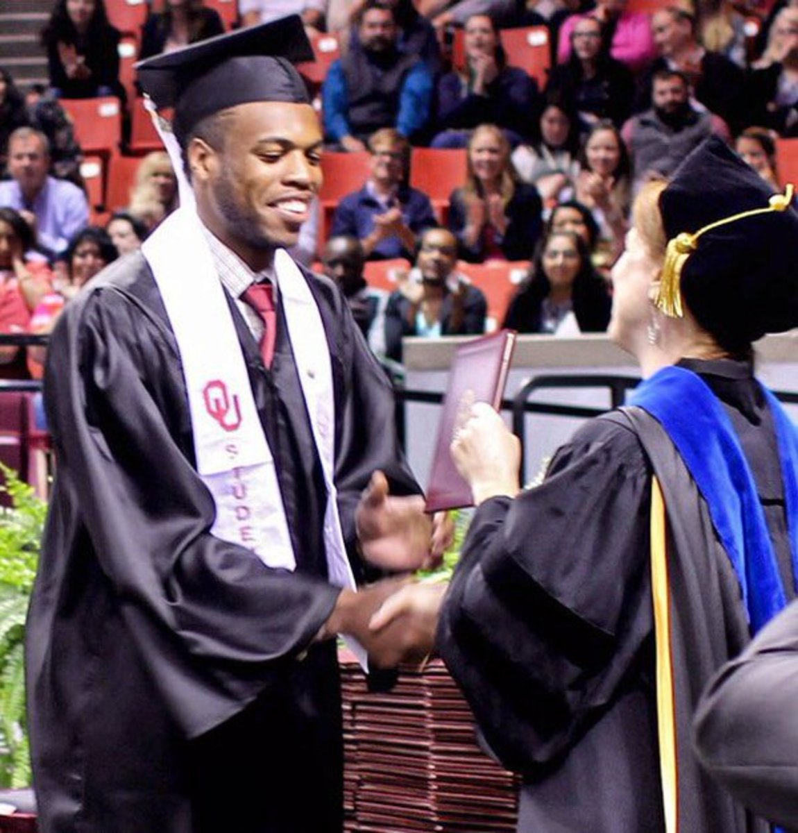 Buddy Hield walks at Oklahoma commencement.