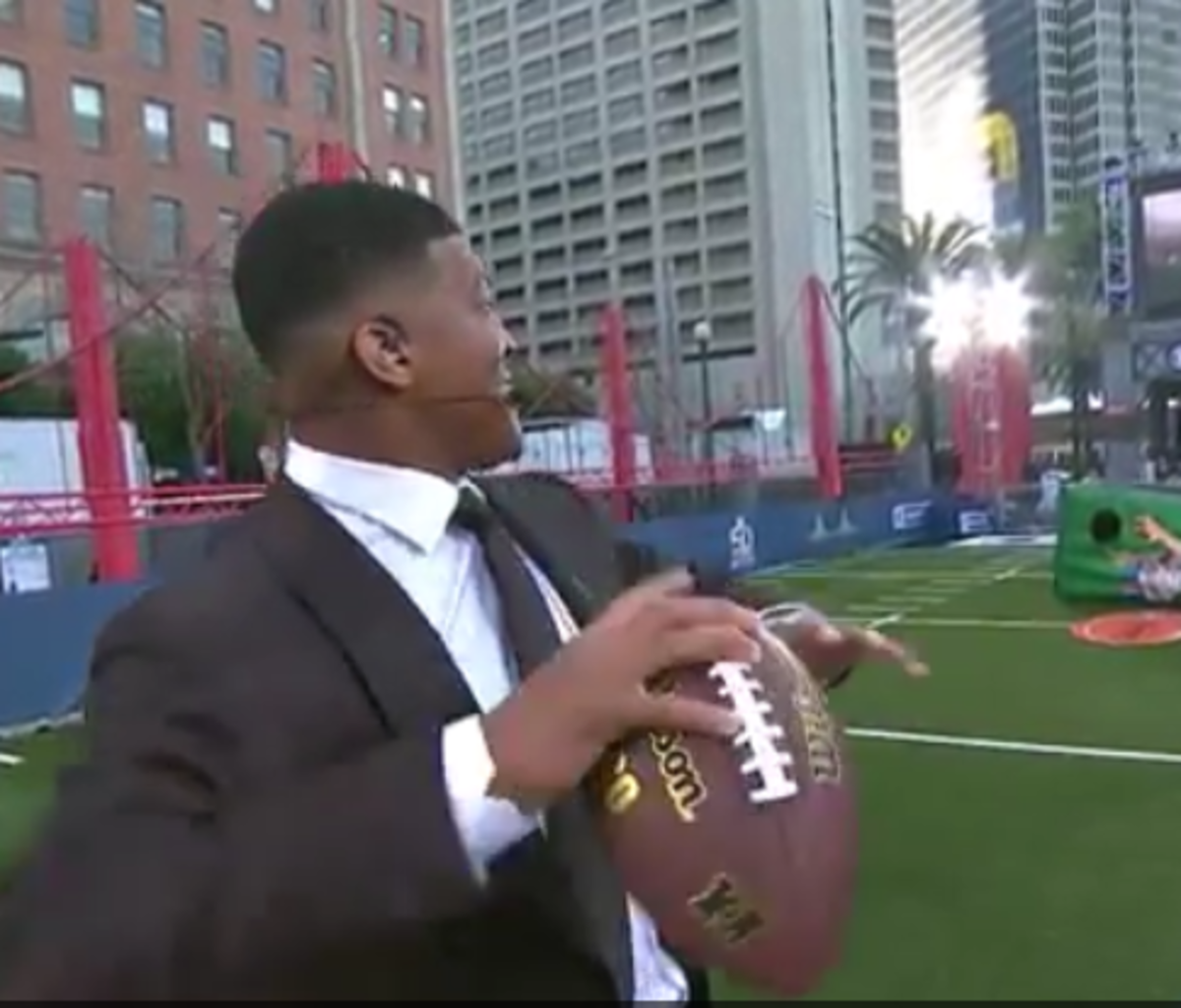 Jameis Winston dominates throwing competition in a suit.