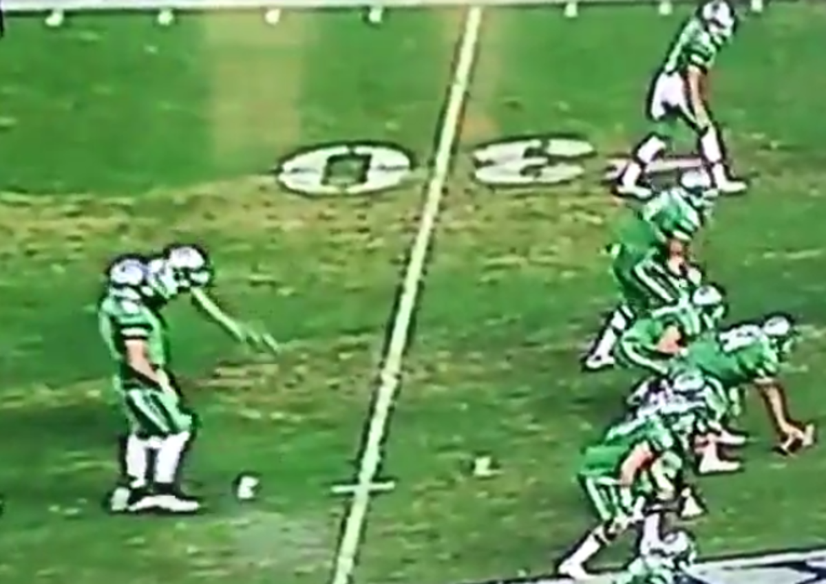 A North Texas running back barfs on the field.
