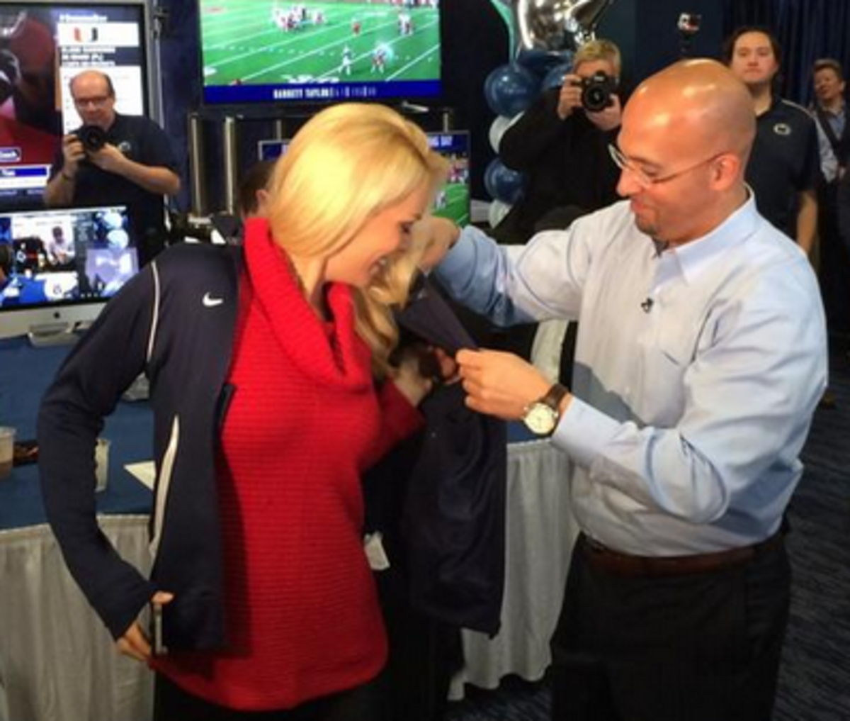James Franklin gives Britt McHenry a blue jacket to wear.