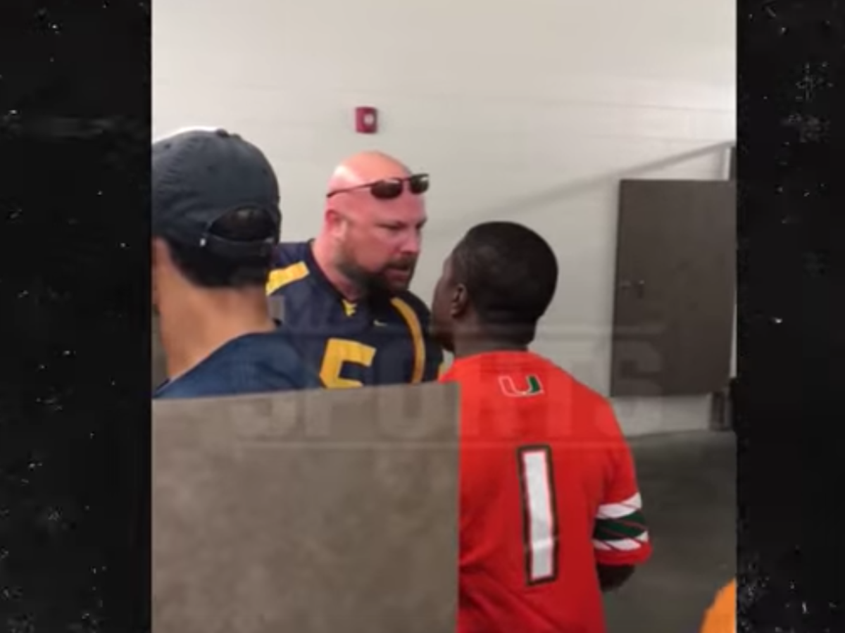 A Miami fan and a West Virginia fan square off in the bathroom.