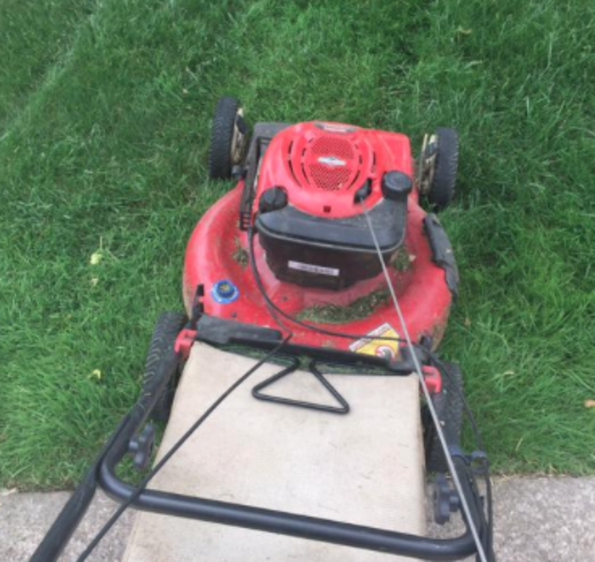 Tyvis Powell with a Lawn Mower.