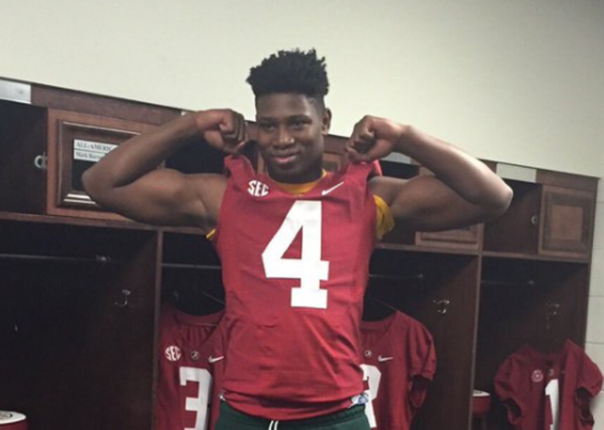 Christopher Allen trying on an Alabama jersey.