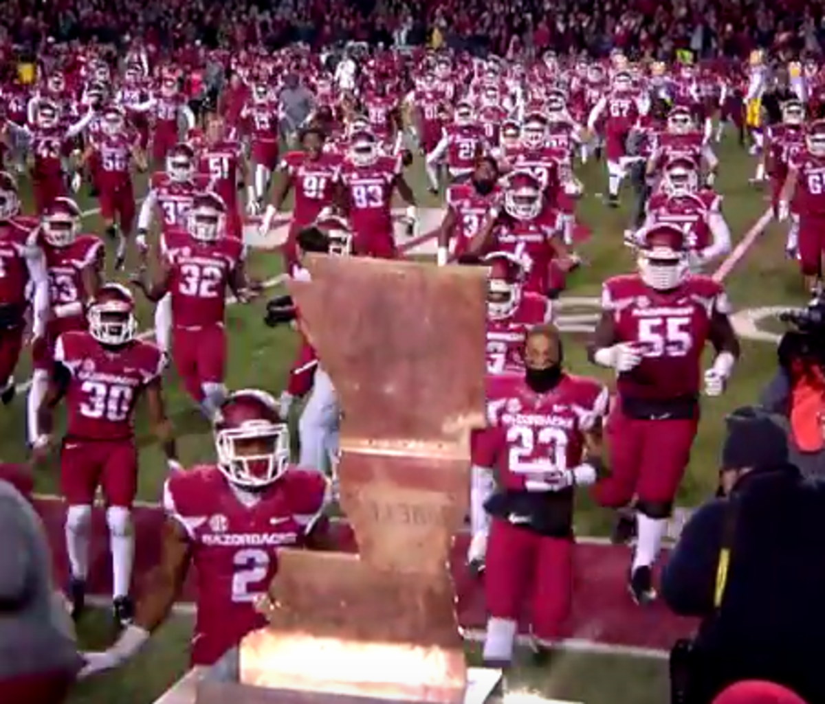 Arkansas players run over to the boot trophy.