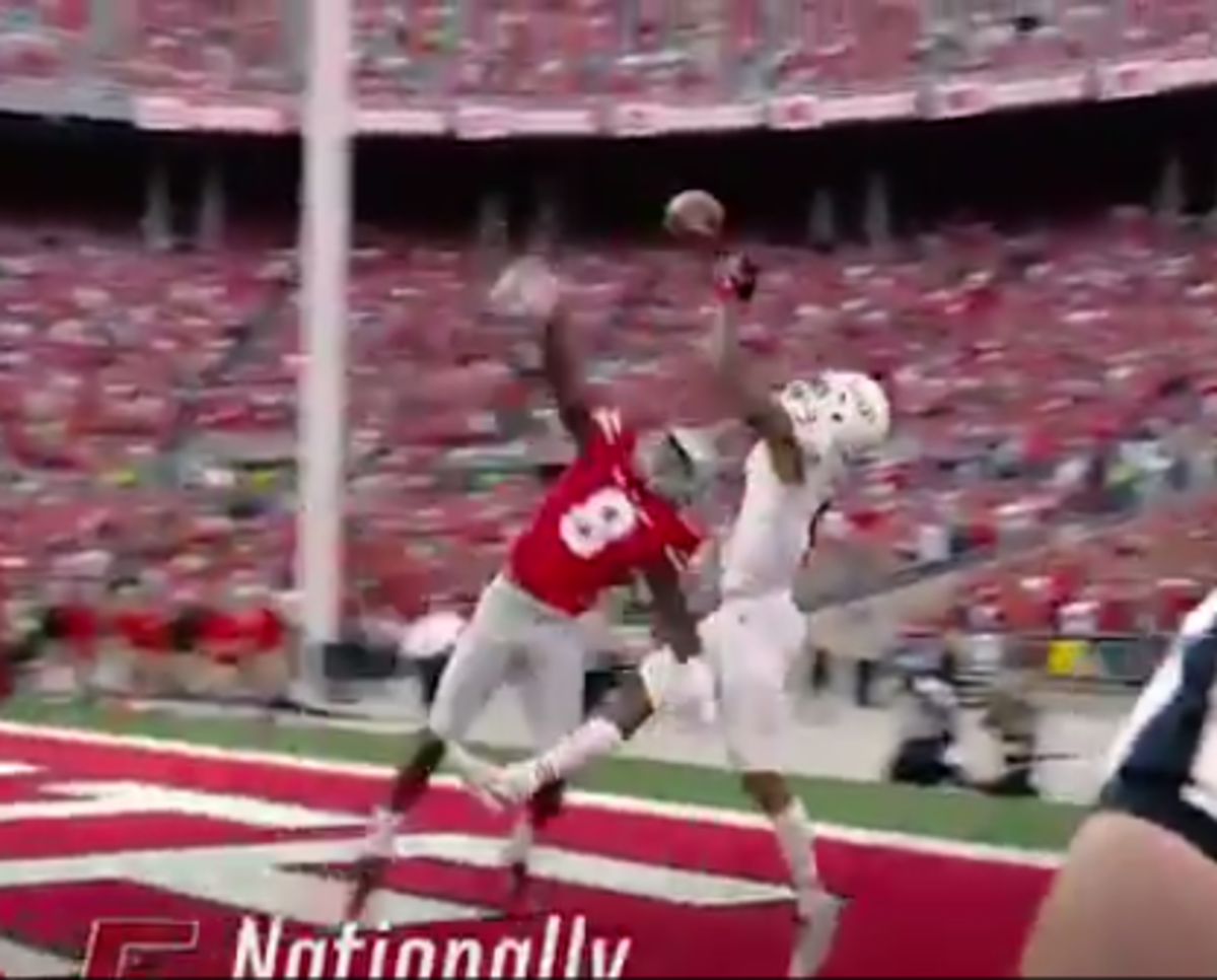 Ohio State player defends a ball in the air.