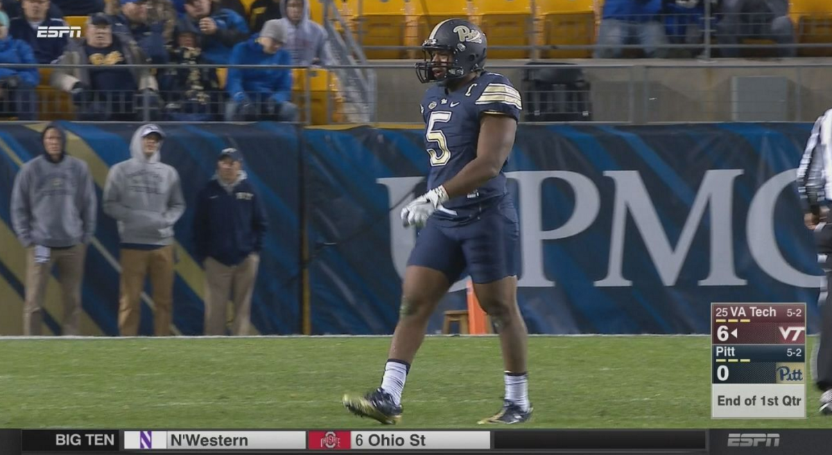 A Pitt player walking across the field.
