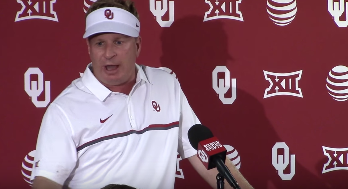 Mike Stoops speaking at the Oklahoma podium.