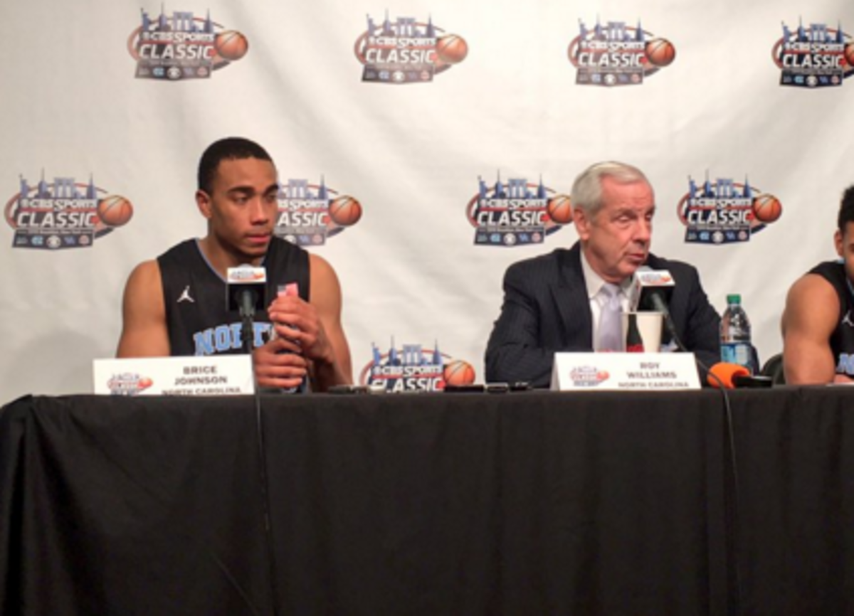 Brice Johnson of UNC talks during a press conference with Roy Williams.