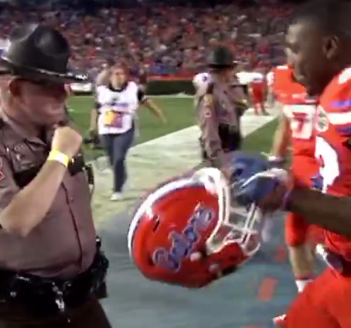 A Florida player dances with a police officer after beating Ole Miss.