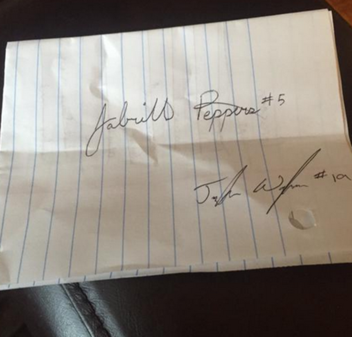 Jabrill Peppers Autographs a piece of paper.