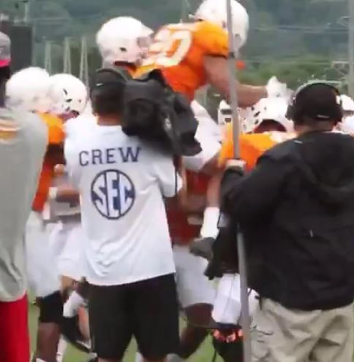 Tennessee players swarm together at practice.
