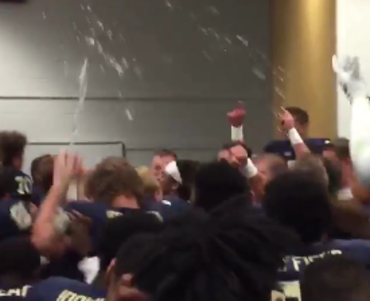 Pitt football players celebrate in the locker room after beating Georgia Tech.