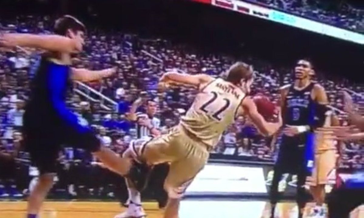 Grayson Allen sticks out his leg and trips an opponent.