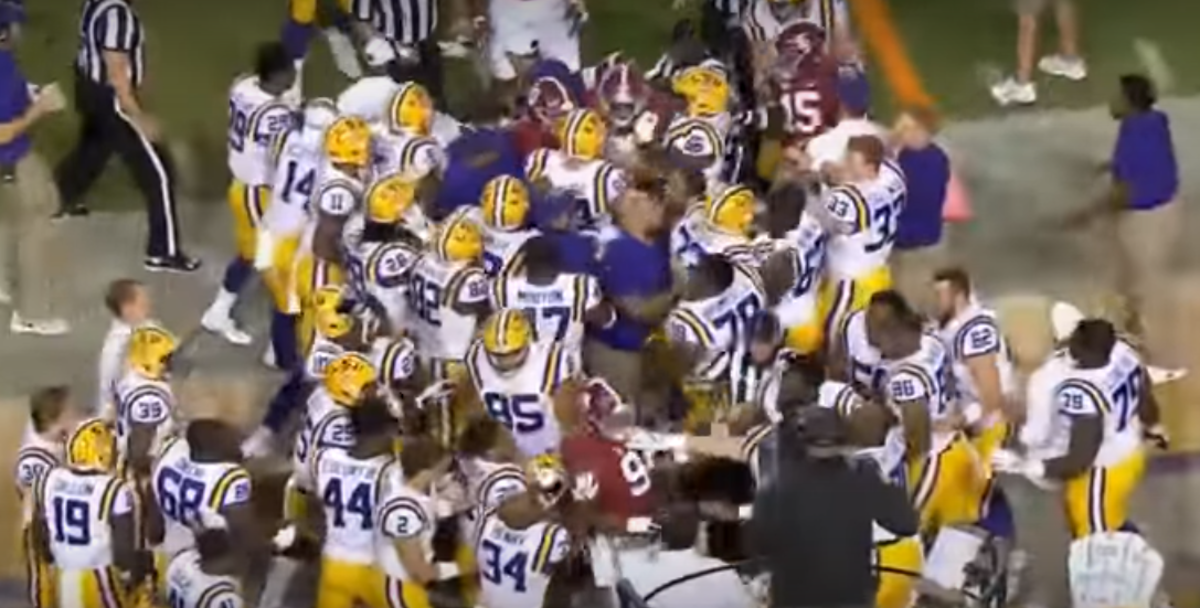 Alabama and LSU players fight on the field.