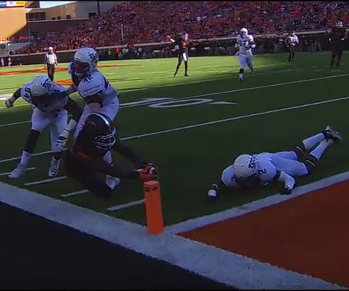 An Oklahoma State player reaches for the goal line.