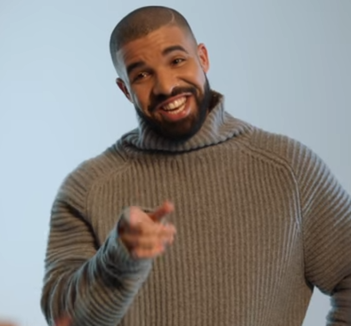 Drake wears a sweater during a commercial.