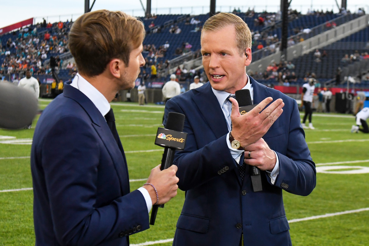 Chris Simms on the field for NBC covering a game.