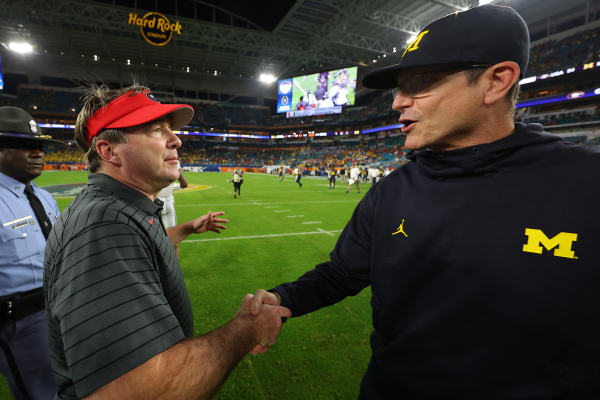Kirby Smart and Jim Harbaugh shake hands at midfield after a game.