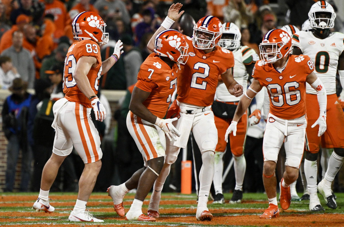 CLEMSON, SOUTH CAROLINA - NOVEMBER 19: Hampton Earle #83, Kobe Pace #7, Cade Klubnik #2, and Tye Herbstreit #86 of the Clemson Tigers celebrates Pace's fourth quarter touchdown against the Miami Hurricanes at Memorial Stadium on November 19, 2022 in Clemson, South Carolina. (Photo by Eakin Howard/Getty Images)