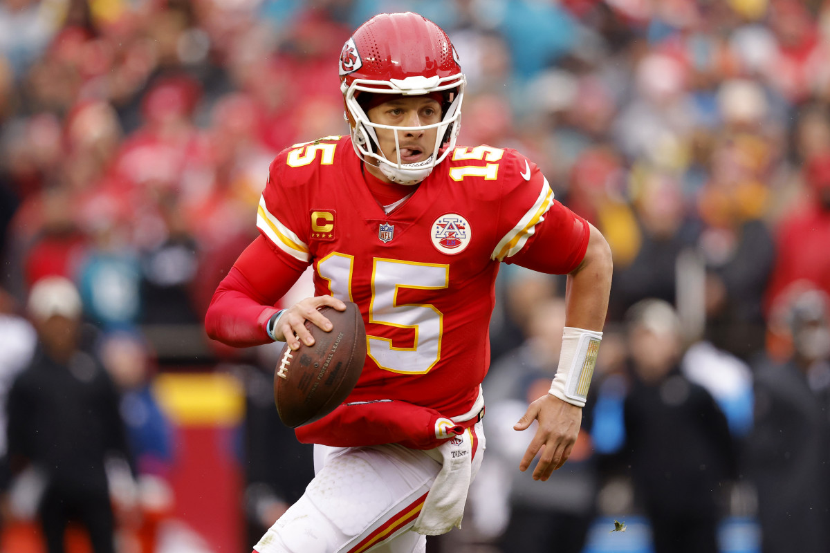 KANSAS CITY, MISSOURI - JANUARY 21: Patrick Mahomes #15 of the Kansas City Chiefs scrambles to throw a touchdown pass against the Jacksonville Jaguars during the first quarter in the AFC Divisional Playoff game at Arrowhead Stadium on January 21, 2023 in Kansas City, Missouri. (Photo by David Eulitt/Getty Images)