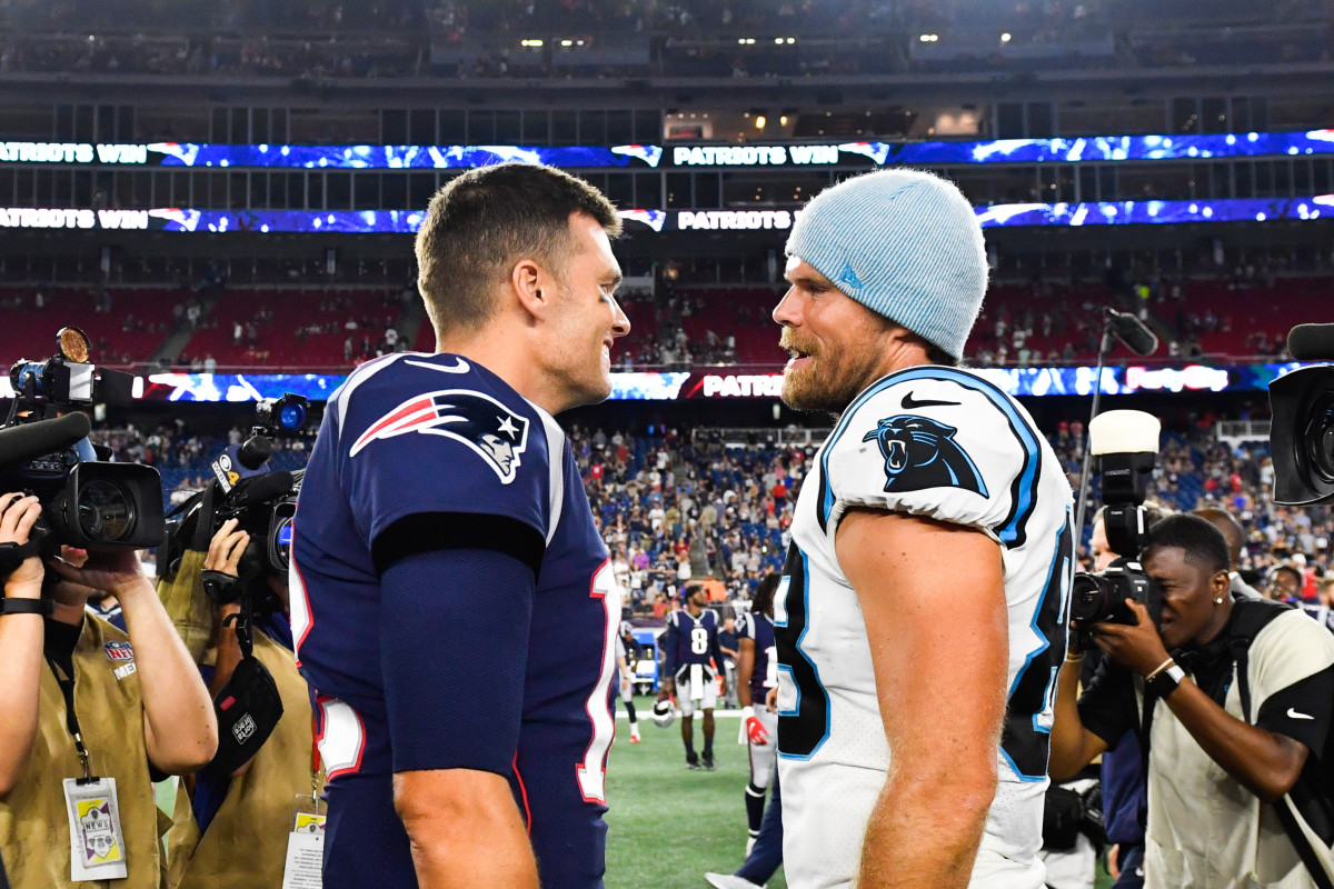 FOXBOROUGH, MA - AUGUST 22: Tom Brady #12 of the New England Patriots meets with Greg Olsen #88 of the Carolina Panthers following the Patriots 10-3 preseason victory at Gillette Stadium on August 22, 2019 in Foxborough, Massachusetts. (Photo by Kathryn Riley/Getty Images)