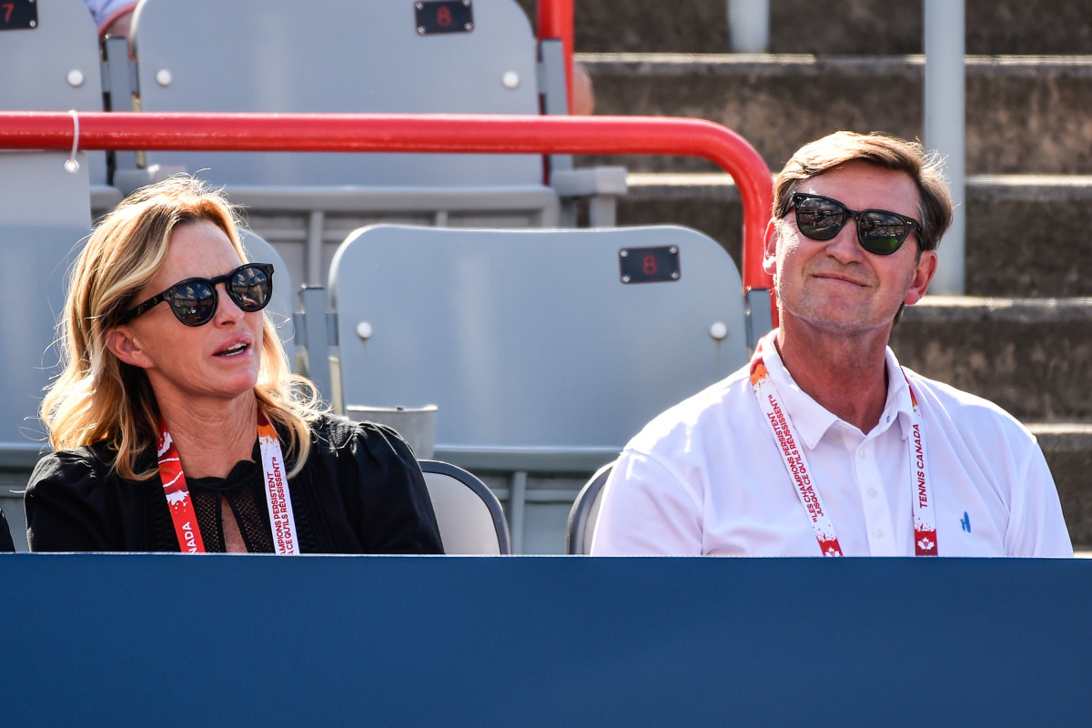 Janet Jones Gretzky watches a tennis match alongside her husband, hockey great Wayne Gretzky.
