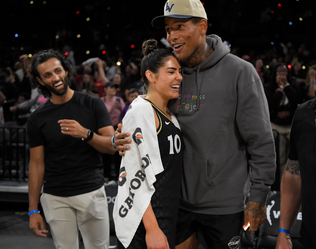 Darren Waller congratulates Kelsey Plum after a WNBA playoff game.