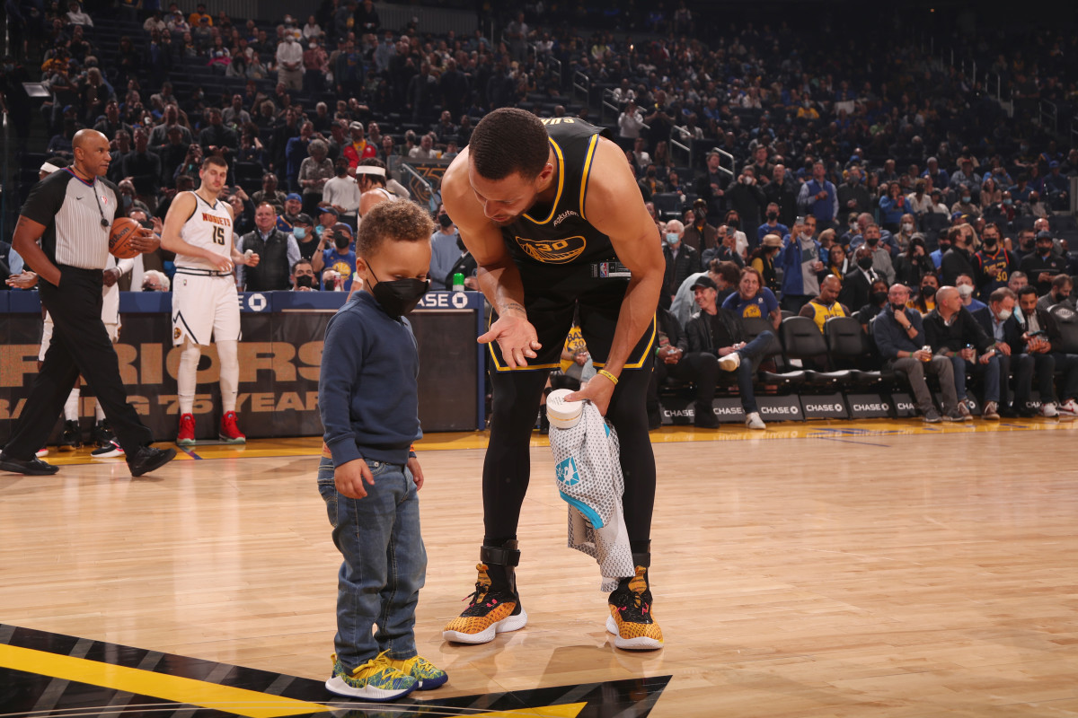 Steph Curry with his son Canon on the court.