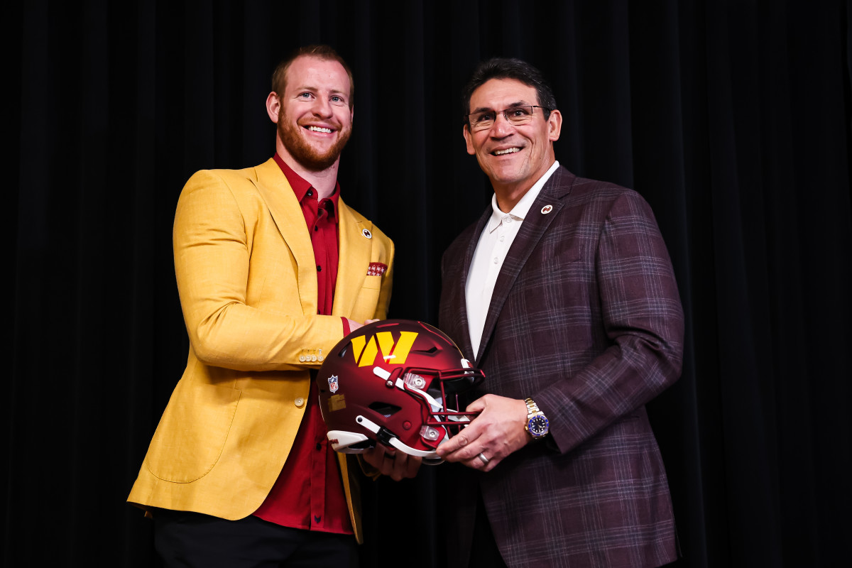 ASHBURN, VA - MARCH 17: Quarterback Carson Wentz of the Washington Commanders shakes hands with head coach Ron Rivera after being introduced at Inova Sports Performance Center on March 17, 2022 in Ashburn, Virginia. (Photo by Scott Taetsch/Getty Images)