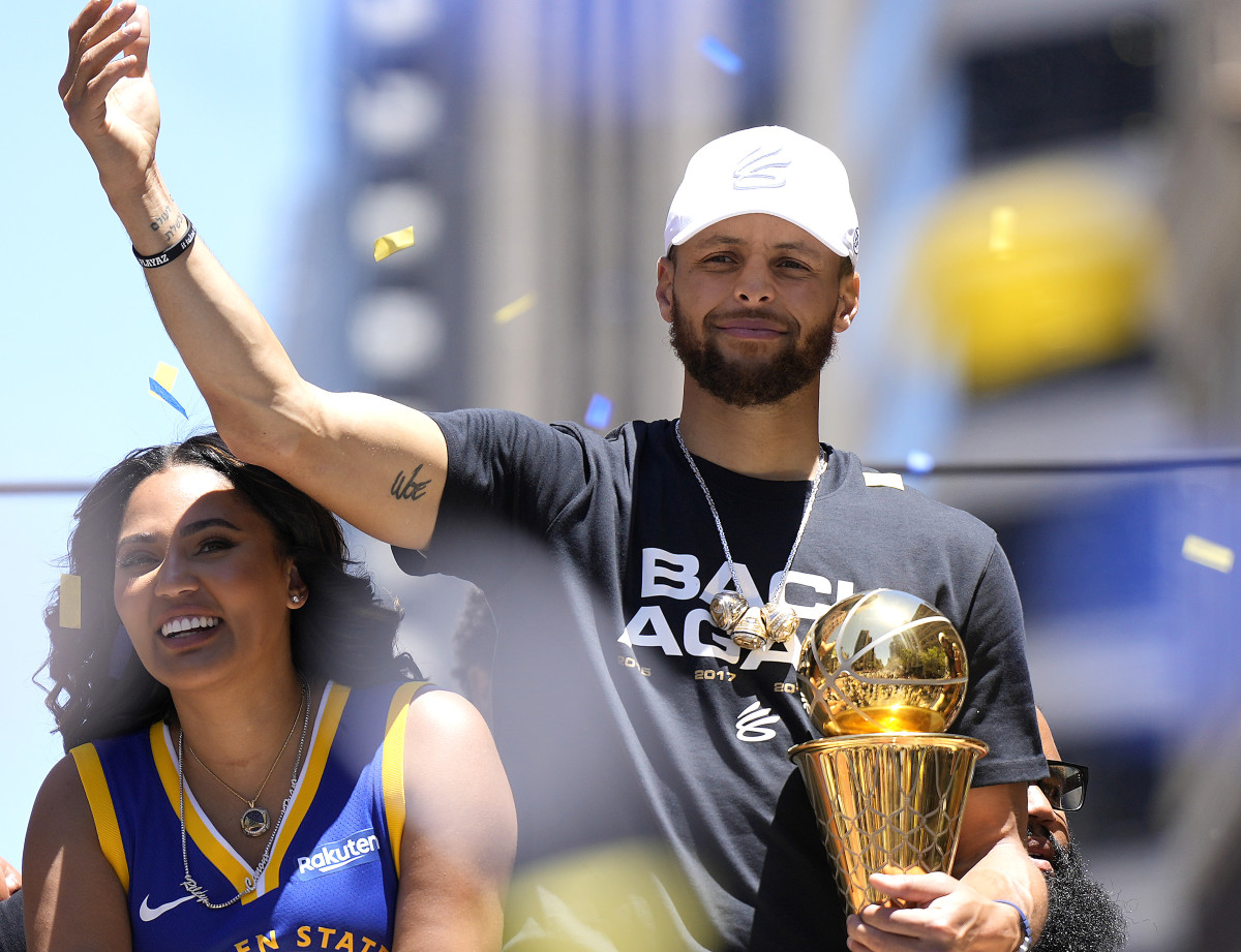 Steph Curry and Ayesha Curry celebrating at the Warriors championship parade.
