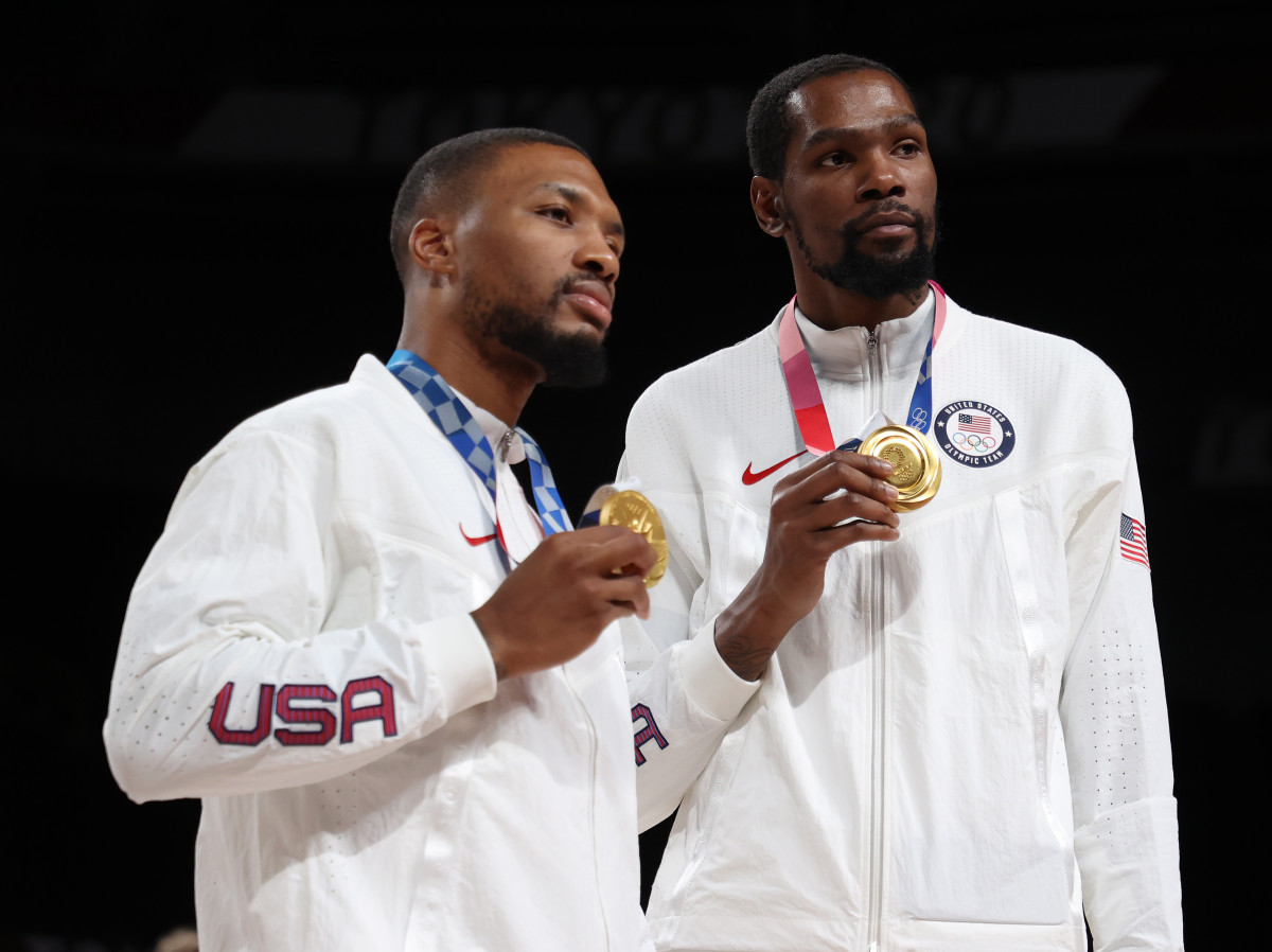 SAITAMA, JAPAN - AUGUST 07: Damian Lillard and Kevin Durant  pose for photographs with their gold medals during the Men's Basketball medal ceremony on day fifteen of the Tokyo 2020 Olympic Games at Saitama Super Arena on August 07, 2021 in Saitama, Japan. (Photo by Gregory Shamus/Getty Images)