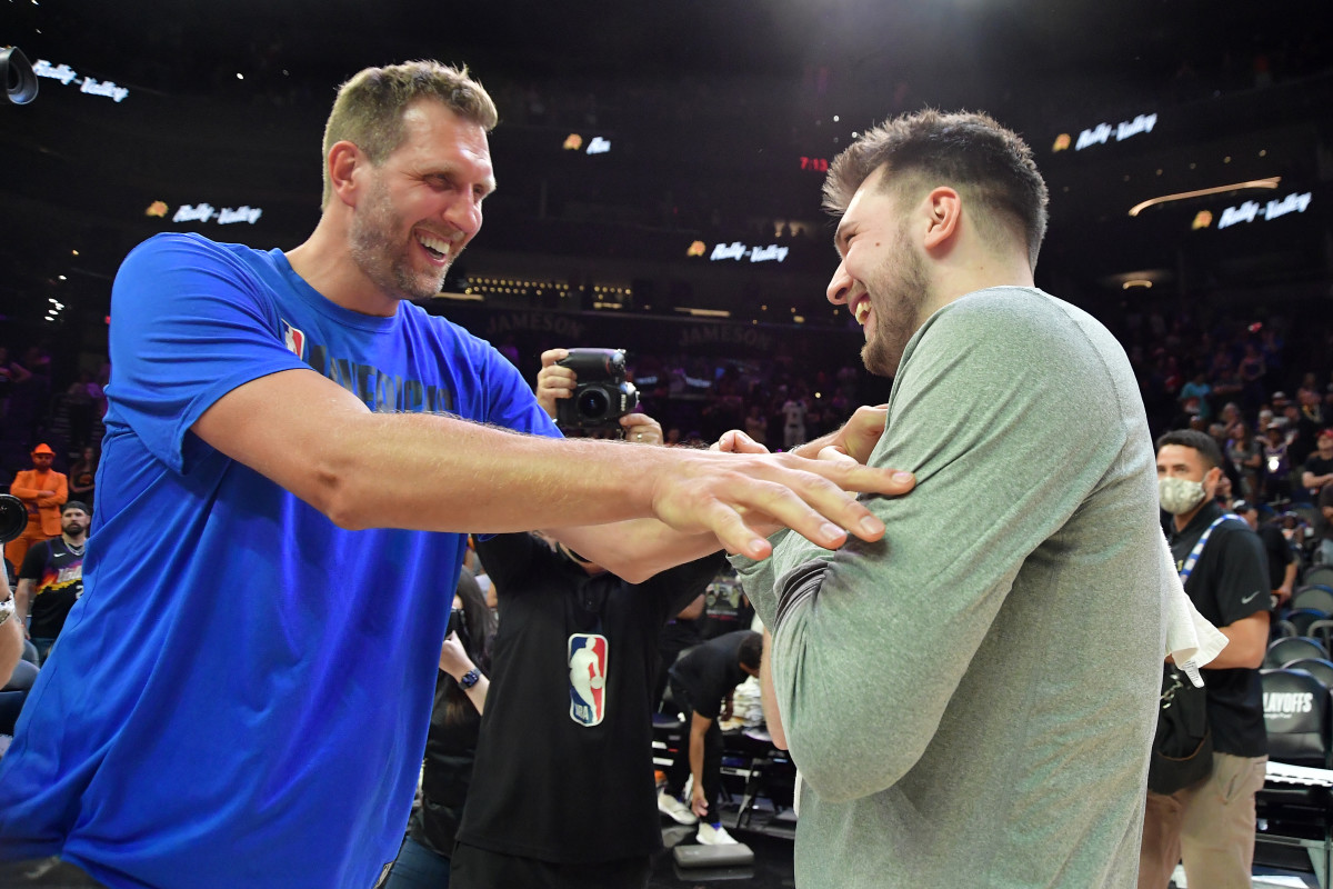 PHOENIX, AZ - MAY 15: NBA Legend, Dirk Nowitzki, congratulates Luka Doncic #77 of the Dallas Mavericks after the game against the Phoenix Suns during Game 7 of the 2022 NBA Playoffs Western Conference Semifinals on May 15, 2022 at Footprint Center in Phoenix, Arizona. NOTE TO USER: User expressly acknowledges and agrees that, by downloading and or using this photograph, user is consenting to the terms and conditions of the Getty Images License Agreement. Mandatory Copyright Notice: Copyright 2022 NBAE (Photo by Michael Gonzales/NBAE via Getty Images)