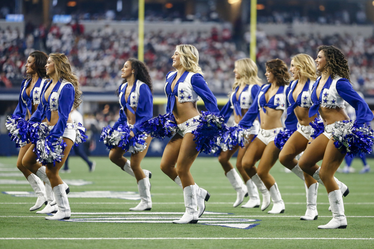 Dallas Cowboys Cheerleaders perform on the field during a playoff game.