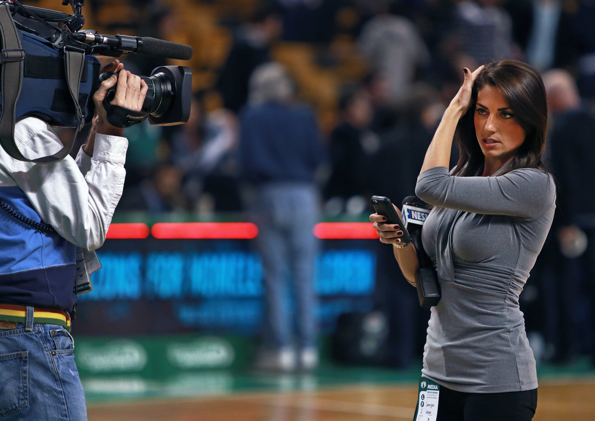 BOSTON - MARCH 12: NESN reporter Jenny Dell checks her hair as she gets ready to do a standup on the parquet floor at the conclusion of the Celtics-Knicks game. The Boston Celtics hosted the New York Knicks in an NBA regular season game at the TD Garden. (Photo by Jim Davis/The Boston Globe via Getty Images)