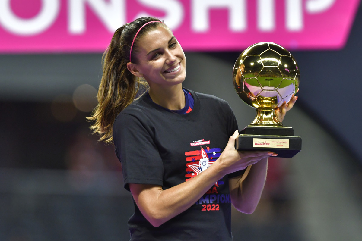 United States women's national team star Alex Morgan on the pitch receiving an award.