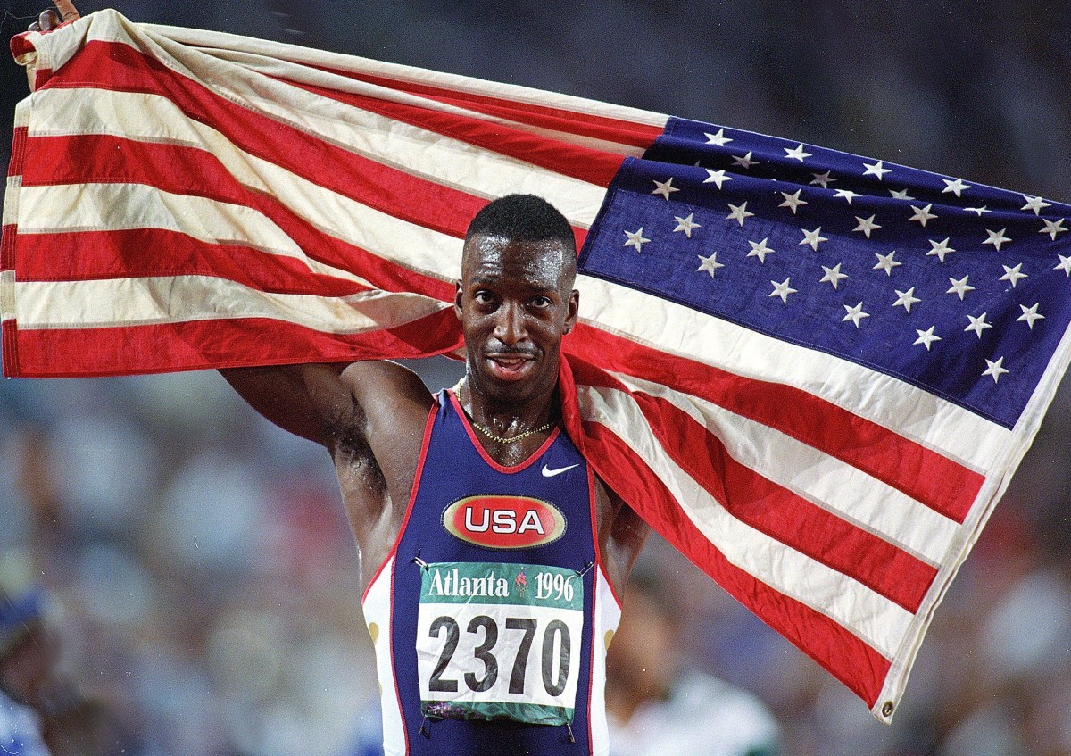 29 Jul 1996:  Michael Johnson of the USA carries the American Flag after winning the Gold in the Men''s 200 meters during the 1996 Olympic Games at the Olympic Stadium in Atlanta, Georgia. Mandatory Credit: Mike Hewitt  /Allsport
