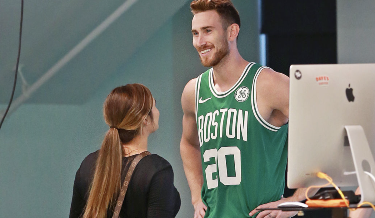 BOSTON, MA - SEPTEMBER 13: Boston Celtics' Gordon Hayward smiles in uniform with his wife Robyn, left, during a photo shoot after meeting with the media at the team's practice facility in the Brighton neighborhood of Boston to give an update on his condition as he comes back from the left ankle/foot injury he suffered during last season's opening game in Cleveland on Sep. 13, 2018. (Photo by Jim Davis/The Boston Globe via Getty Images)