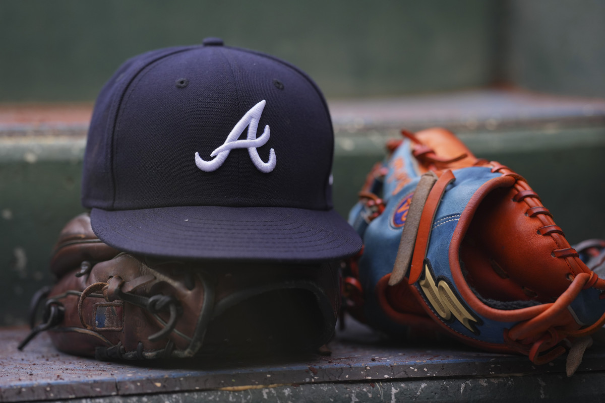 PHILADELPHIA, PA - JULY 26: A general view of gloves and an Atlanta Braves hat against the Philadelphia Phillies at Citizens Bank Park on July 26, 2022 in Philadelphia, Pennsylvania. The Braves defeated the Phillies 6-3. (Photo by Mitchell Leff/Getty Images)