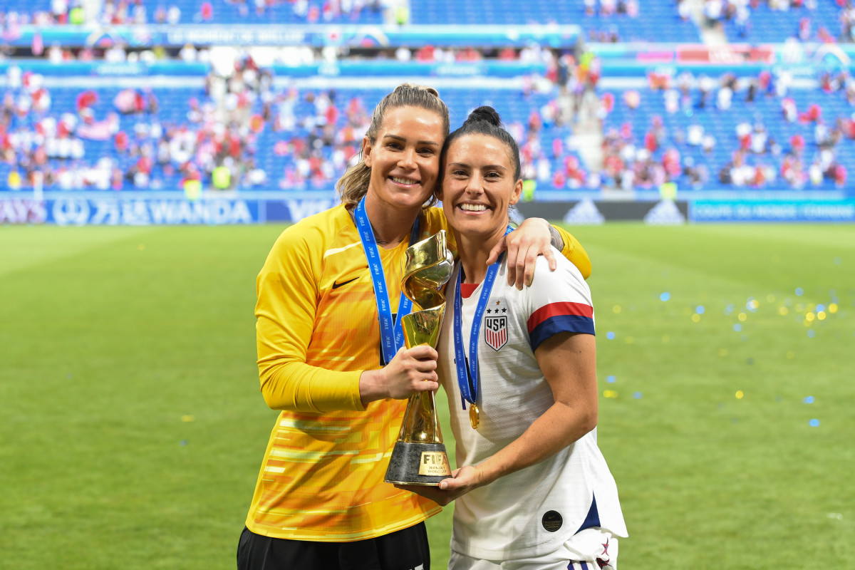 LYON, FRANCE - JULY 07: Ashlyn Harris #18 and teammate Ali Krieger #11 pose with the World Cup after the 2019 FIFA Women's World Cup France final match between the Netherlands and the United States at Stade de Lyon on July 07, 2019 in Lyon, France.  (Photo by Brad Smith/isiphotos.com/Getty Images)