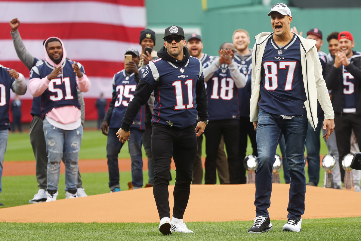 BOSTON, MASSACHUSETTS - APRIL 09: Julian Edelman and Rob Gronkowksi of the New England Patriots look on after throwing out the ceremonial first pitch before the Red Sox home opening game against the Toronto Blue Jays at Fenway Park on April 09, 2019 in Boston, Massachusetts. (Photo by Maddie Meyer/Getty Images)