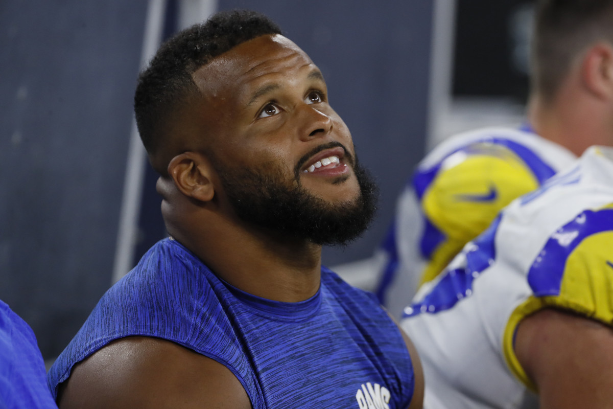 Rams star Aaron Donald sits on the bench during a preseason game.