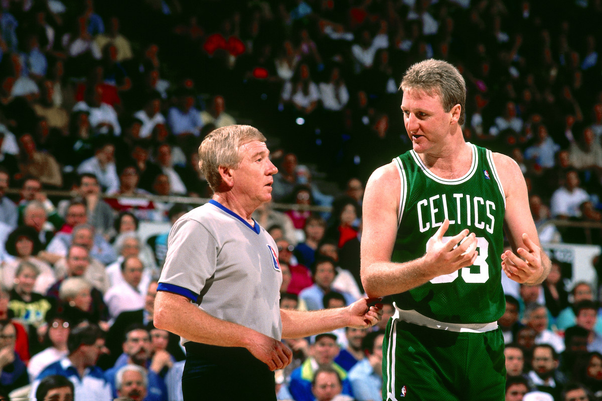 Larry Bird speaking to a referee.