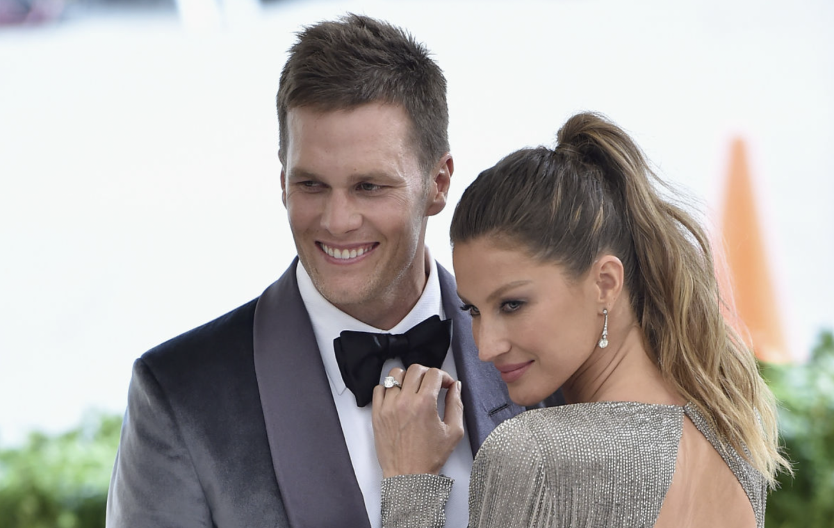 Tom Brady and his wife Gisele on the red carpet for an event.