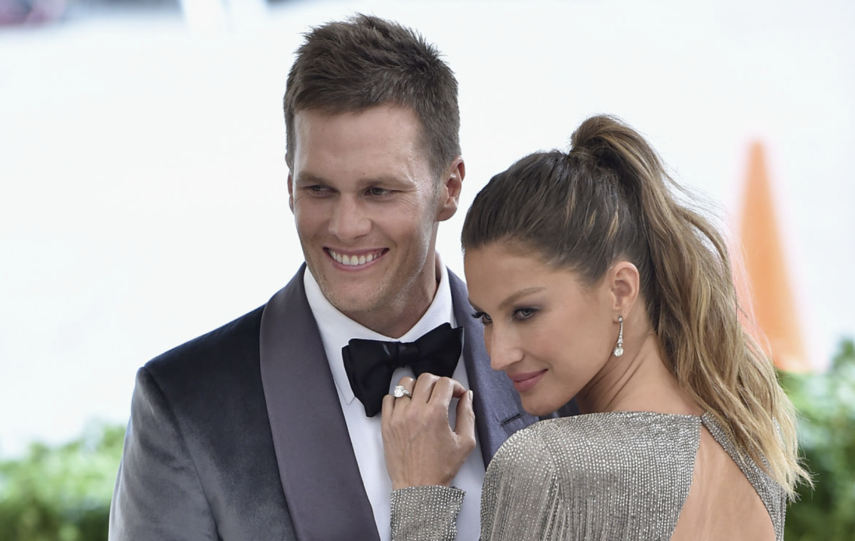 Tom Brady and his wife, Gisele, on the red carpet for an event.